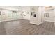 Spacious living room featuring hardwood floors and plenty of natural light from the shuttered windows at 2608 Calvano Dr, Land O Lakes, FL 34639