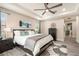 Comfortable main bedroom with a ceiling fan, large windows, and ensuite bathroom at 2608 Calvano Dr, Land O Lakes, FL 34639