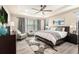 Spacious main bedroom with a tray ceiling, ceiling fan, and large windows at 2608 Calvano Dr, Land O Lakes, FL 34639