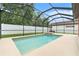 Inviting screened-in pool and spa with a spacious deck for relaxation at 2608 Calvano Dr, Land O Lakes, FL 34639