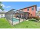 Beautiful screened-in pool with a spacious patio and well-maintained landscaping at 2608 Calvano Dr, Land O Lakes, FL 34639