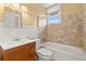 Bright bathroom features a classic vanity, tiled shower-tub combo, and window letting in natural light at 2628 2Nd N Ave, St Petersburg, FL 33713
