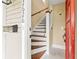 Charming home entryway showcasing a wooden staircase, red door, and tiled floor at 2628 2Nd N Ave, St Petersburg, FL 33713