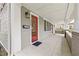 Inviting covered front porch with a red door, traditional lantern, and a mail slot at 2628 2Nd N Ave, St Petersburg, FL 33713