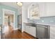 Bright kitchen with stainless steel appliances, white cabinets, and farm sink near doorway at 2628 2Nd N Ave, St Petersburg, FL 33713