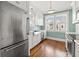 Bright kitchen with stainless steel appliances, white cabinets, and farm sink below three windows at 2628 2Nd N Ave, St Petersburg, FL 33713