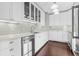 Modern kitchen with white cabinets, stainless steel appliances, and tile backsplash at 2628 2Nd N Ave, St Petersburg, FL 33713