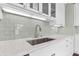 Close-up of modern kitchen with white cabinets, stainless steel appliances, and tile backsplash at 2628 2Nd N Ave, St Petersburg, FL 33713