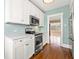 Bright kitchen features stainless steel appliances, white cabinets and subway tile backsplash at 2628 2Nd N Ave, St Petersburg, FL 33713