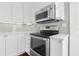 Gourmet kitchen boasting stainless steel oven and microwave with stylish gray backsplash at 2628 2Nd N Ave, St Petersburg, FL 33713