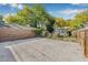 Spacious gravel parking area leading to a quaint backyard with a charming cottage and lush greenery at 2710 2Nd N Ave, St Petersburg, FL 33713