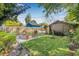 Well-manicured backyard with lush lawn, established trees, a small shed, and cozy patio seating area at 2710 2Nd N Ave, St Petersburg, FL 33713