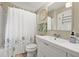 Cozy bathroom features a shower-tub combination, large white vanity, and decorative shower curtain at 2710 2Nd N Ave, St Petersburg, FL 33713