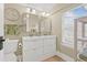 Bathroom with dual sinks, bright lighting, and a neutral color palette creating a refreshing and functional space at 2710 2Nd N Ave, St Petersburg, FL 33713