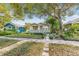 Charming single-story home with green siding, manicured lawn, and a welcoming front porch at 2710 2Nd N Ave, St Petersburg, FL 33713