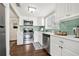 Well-lit kitchen featuring stainless steel appliances, light countertops, and eye-catching green subway tile backsplash at 2710 2Nd N Ave, St Petersburg, FL 33713