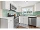 Updated kitchen features modern appliances, light countertops, and ample natural light from the window at 2710 2Nd N Ave, St Petersburg, FL 33713