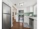 Bright kitchen boasts stainless steel appliances, white cabinetry, light countertops, and a garden window at 2710 2Nd N Ave, St Petersburg, FL 33713