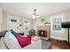 Bright living room featuring a brick fireplace, hardwood floors, and comfortable seating at 2710 2Nd N Ave, St Petersburg, FL 33713