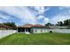 Backyard featuring green lawn and the home's exterior, which includes a screened porch at 29042 Rivergate Run, Wesley Chapel, FL 33543