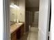 Bathroom featuring a sink, a glass shower, a bath tub, and a vanity with granite countertop at 29042 Rivergate Run, Wesley Chapel, FL 33543
