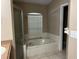 Spacious bathroom featuring a glass shower, a bathtub, and a vanity with granite countertop at 29042 Rivergate Run, Wesley Chapel, FL 33543