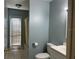 Clean bathroom with tiled floors, a toilet, vanity with sink, and a door to the shower at 29042 Rivergate Run, Wesley Chapel, FL 33543