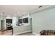 Open-concept kitchen with dark cabinets, quartz countertops, stainless steel appliances, and seamless flow to the living area at 29042 Rivergate Run, Wesley Chapel, FL 33543