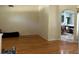 Bright and airy living room with hardwood floors, an archway view into the modern kitchen at 29042 Rivergate Run, Wesley Chapel, FL 33543