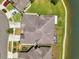 An aerial view shows a home's roof, screened in porch, well manicured lawn and waterfront location at 30327 Lettingwell Cir, Wesley Chapel, FL 33543