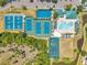 Aerial view showcasing the community pool, playground, tennis and basketball courts at 30327 Lettingwell Cir, Wesley Chapel, FL 33543
