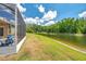 Beautiful pond and lawn as seen from the screened in patio at 30327 Lettingwell Cir, Wesley Chapel, FL 33543
