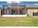 Enjoy outdoor living with a covered patio and spacious backyard featuring a lush lawn and garden at 30327 Lettingwell Cir, Wesley Chapel, FL 33543