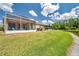 Spacious backyard featuring well-maintained lawn and pond views at 30327 Lettingwell Cir, Wesley Chapel, FL 33543