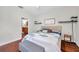 Bedroom featuring hardwood floors, a queen bed, and an ensuite bathroom at 30327 Lettingwell Cir, Wesley Chapel, FL 33543