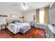 Comfortable bedroom with a ceiling fan, hardwood floors, and stylish decor at 30327 Lettingwell Cir, Wesley Chapel, FL 33543