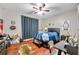 Bedroom featuring dark furniture, hardwood floors, and a ceiling fan, with personal decor accents at 30327 Lettingwell Cir, Wesley Chapel, FL 33543
