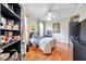 Bright bedroom with wood floors, a ceiling fan, quirky bedding, and colorful decor at 30327 Lettingwell Cir, Wesley Chapel, FL 33543
