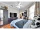 Bedroom showcasing wood flooring, a modern dresser, and neutral wall paint at 30327 Lettingwell Cir, Wesley Chapel, FL 33543
