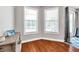 Den with natural light, hardwood floors, and desk at 30327 Lettingwell Cir, Wesley Chapel, FL 33543