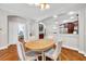 Open-concept dining room features hardwood floors, is bright, and is conveniently located near the kitchen at 30327 Lettingwell Cir, Wesley Chapel, FL 33543