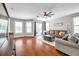 Bright living room features hardwood floors and comfortable seating for relaxing or entertaining at 30327 Lettingwell Cir, Wesley Chapel, FL 33543