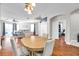 Open-concept living room featuring hardwood floors, modern lighting, and neutral paint at 30327 Lettingwell Cir, Wesley Chapel, FL 33543
