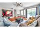 Spacious living room with natural light, a cozy fireplace, and comfortable seating for relaxing or entertaining at 30327 Lettingwell Cir, Wesley Chapel, FL 33543