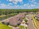 Aerial view of the neighborhood featuring well-kept homes and a scenic lake at 30327 Lettingwell Cir, Wesley Chapel, FL 33543