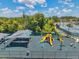Aerial shot of the community playground with slides and covered seating area at 30327 Lettingwell Cir, Wesley Chapel, FL 33543