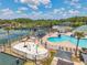 Aerial view of the community pool with splash pad, lounge chairs, and surrounding amenities at 30327 Lettingwell Cir, Wesley Chapel, FL 33543