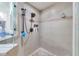 Shower with modern shower head, neutral tile, and built in shelves at 30327 Lettingwell Cir, Wesley Chapel, FL 33543