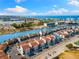 Aerial view of white condos with a view of a marina, bay and a waterfront park at 337 Rex Pl # G, Madeira Beach, FL 33708