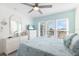 Bright bedroom featuring a ceiling fan, a window, and a television for relaxed viewing at 337 Rex Pl # G, Madeira Beach, FL 33708